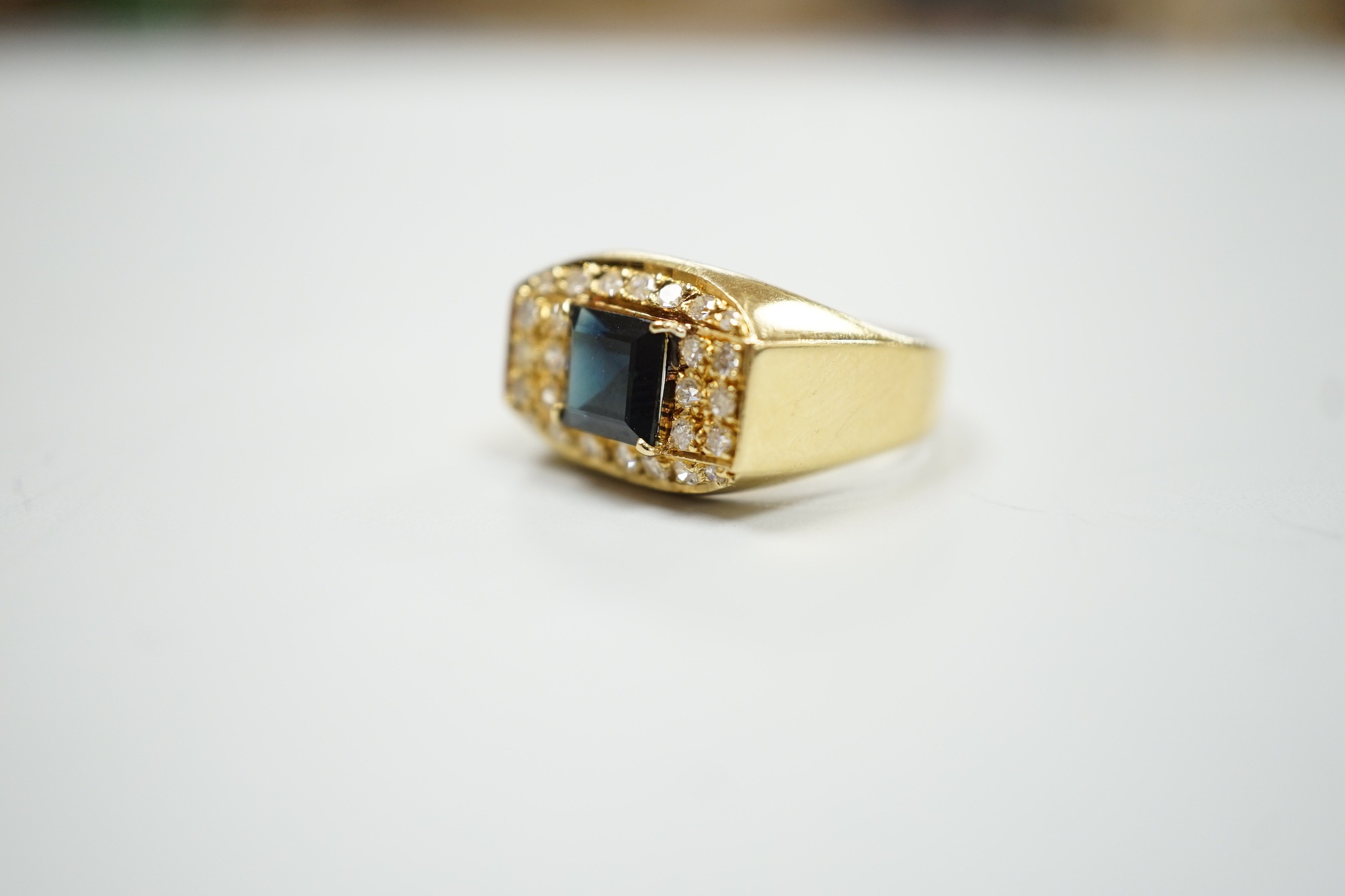 A modern 750 yellow metal, single stone sapphire and pave set diamond dress ring, size O, gross weight 5.9 grams.